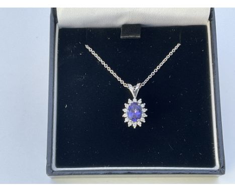 An 18ct white gold tanzanite and diamond star design pendant and chain.