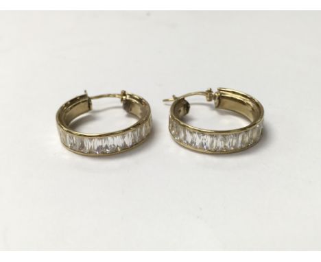 A pair of 9ct gold stone set hoop earrings, weighing approximately 6g.