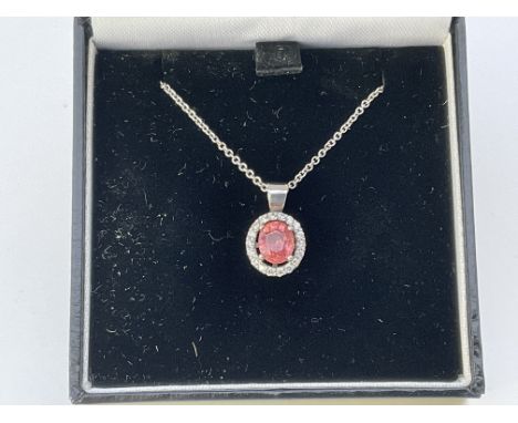 An 18ct white gold pink sapphire and diamond pendant and chain.