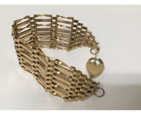 A ladies 9ct gold eight bar gate bracelet with heart shaped padlock clasp weight 16g.