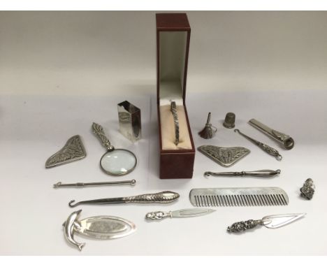 A collection of small silver items including a bangle, comb, magnifying glass etc.