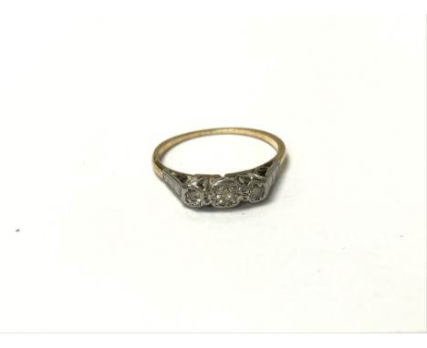 A 1920s ring set with a trio of diamonds. The approximate ring size is between L and M.