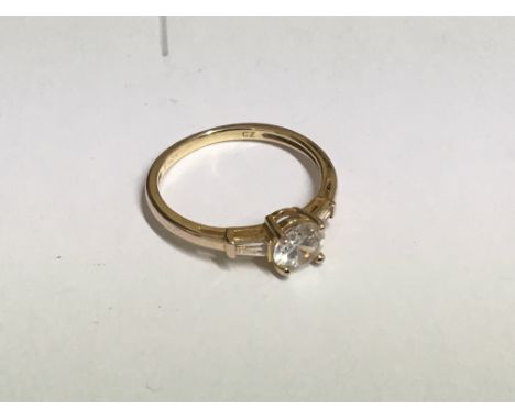 A silver gilt ring set with a CZ solitaire and baguette shoulders. P  - NO RESERVE