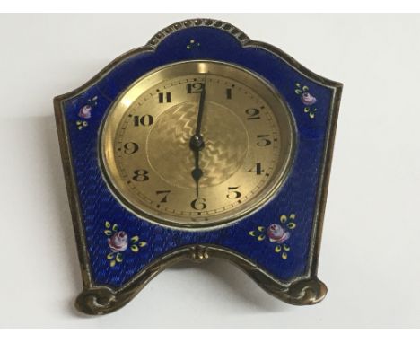An Art Deco bedside clock with enamel floral decoration, strut missing - NO RESERVE