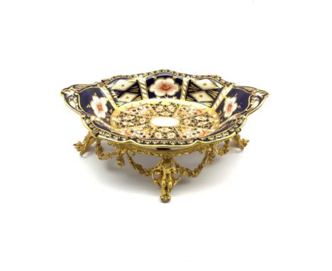 Edwardian Royal Crown Derby Imari pattern dish supported by a 19th century gilt metal stand decorated with floral swags on fo