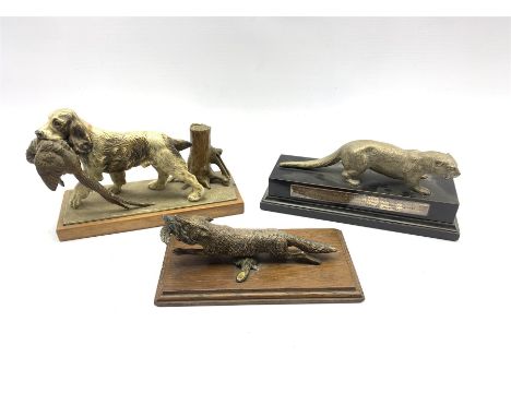 Silver plated model of an otter on wooden base with presentation inscription dated 1953 L27cm, a cold painted spelter model o