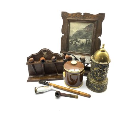 Early 20th century oak pipe rack with inset print, another with silver-plated stag mount, a 19th century brass tobacco jar an