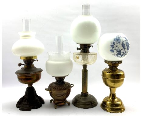 Victorian table oil lamp with glass reservoir and brass column H41cm, another with copper reservoir and iron base and two oth