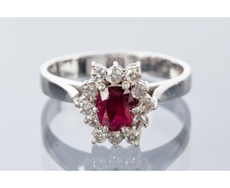 RUBY AND DIAMOND CLUSTER RING
the central oval ruby surrounded by round diamonds, hallmark indistinct, size L