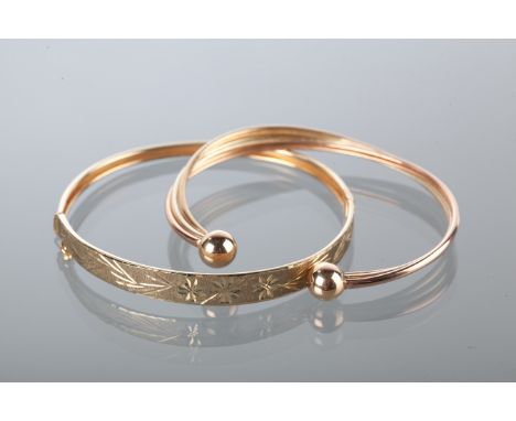 TWO GOLD BANGLES
one torc bangle with white, yellow and rose gold, the other with engraved decoration, c.1970s, both unmarked
