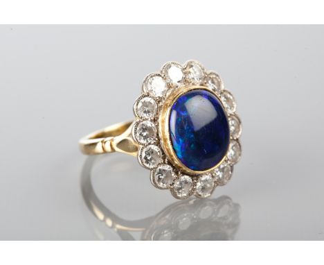 OUTSTANDING OPAL AND DIAMOND CLUSTER RING
with a central oval cabochon black opal, surrounded by brilliant cut diamonds, mark