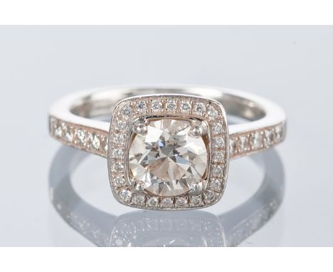 DIAMOND SOLITAIRE RING
the brilliant cut diamond approximately 1.04 carats, surrounded by smaller brilliant cut diamonds in a
