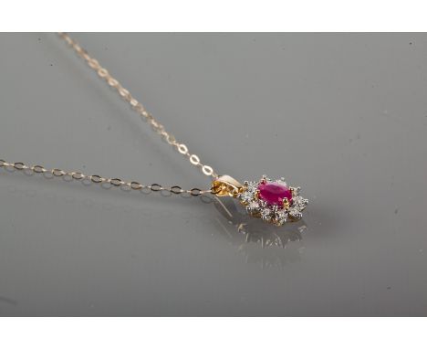 RUBY AND DIAMOND CLUSTER PENDANT
with a central oval ruby surrounded by illusion set diamonds, marked 375 for nine carat gold