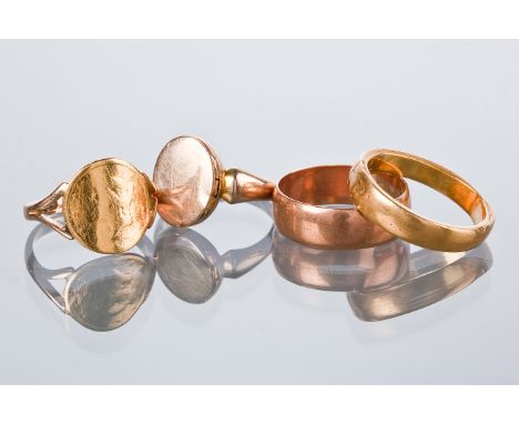 FOUR GOLD RINGS comprising a nine carat gold wedding band, size N; a twenty two carat gold wedding band, approximately size K