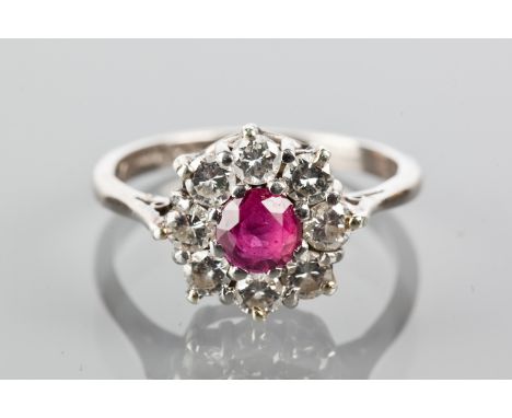 RUBY AND DIAMOND CLUSTER RING
with a central round ruby surrounded by brilliant cut diamonds, marked 18ct and PLAT for eighte