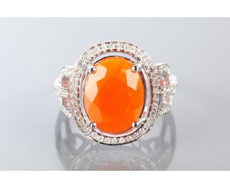 FIRE OPAL AND DIAMOND DRESS RING
set with a central oval fire opal surrounded by diamonds, on trifurcated diamond set shoulde