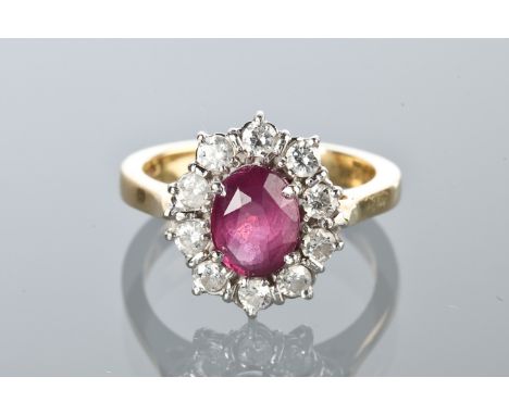 RUBY AND DIAMOND CLUSTER RING
with a central oval ruby surrounded by brilliant cut diamonds, hallmarked for eighteen carat go