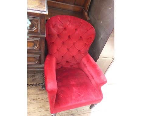 A Victorian red upholstered button back armchair 