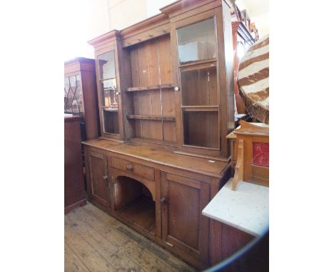 A light oak shelf back dresser with two glazed doors over single drawer, two cupboards and central well