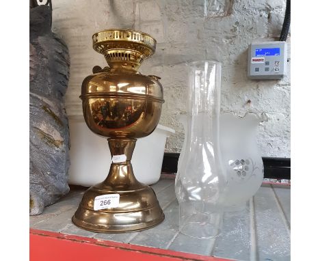 A brass lamp with glass funnel and shade 