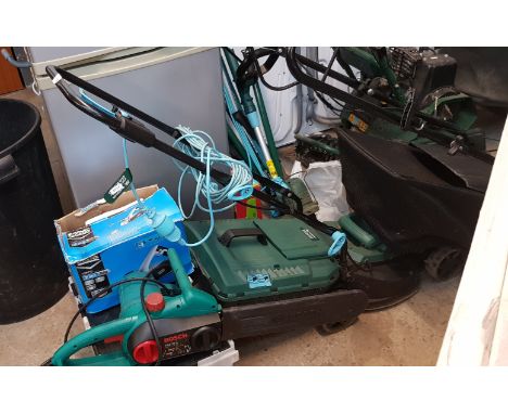 A collection of garden tools including lawnmower, strimmer, hand tools, etc.