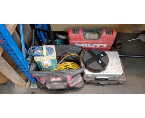 A mixed lot of tools including two 110volt drils, 110volt transformer, two leads, Hilti nail gun,  diamond core drills, 9" gr