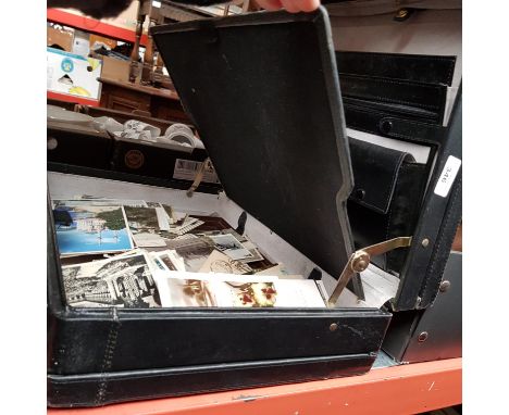 A briefcase of assorted postcards 