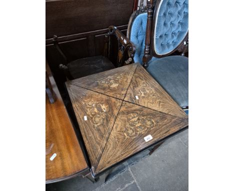 An Edwardinan inlaid rosewood envelope card table with two Ewardian inlaid mahogany chairs. 