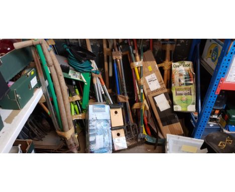 A large collection of garden tools including rakes, scythes, spades, forks, nesting box, garden sprayer, seat, garden hose, f