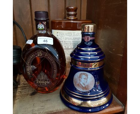 A ceramic Bells whisky commemorating John Logie Baird (still sealed), an unopened litre bottle of Dimple whisky, and a Dougla