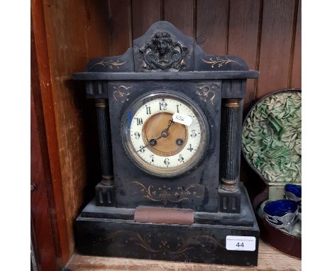 A slate mantle clock bearing inscription dated 1887