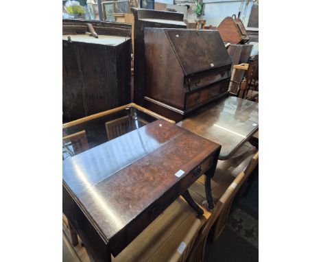 A 1930s walnut bureau together with a walnut sofa table, a mahogany coffee table and a cane and glass top coffee table.