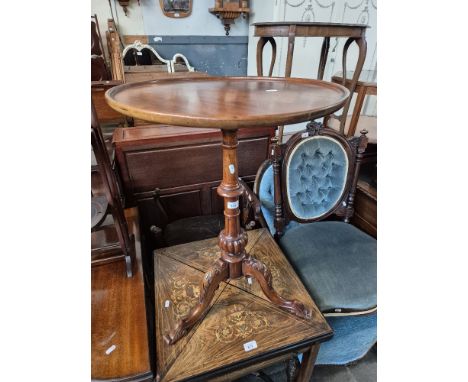 A Victorian carved mahogany snap top tripod table. 