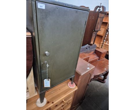 A green painted metal cabinet and a CD cabinet containing CDs. 