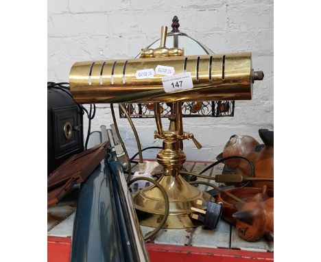 A brass desk lamp and a table lamp with glass shade. 
