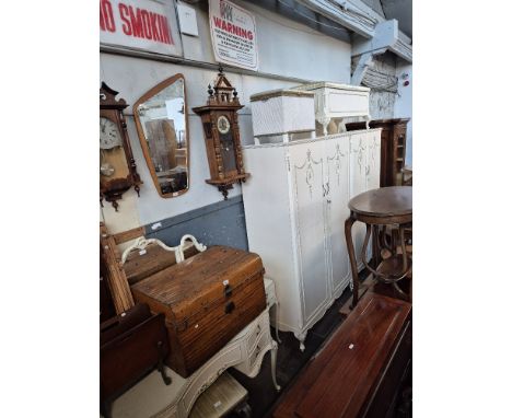 A suite of French style white painted bedroom furniture comprising two wardrobes, ottoman, dressing table, stool, headboard w