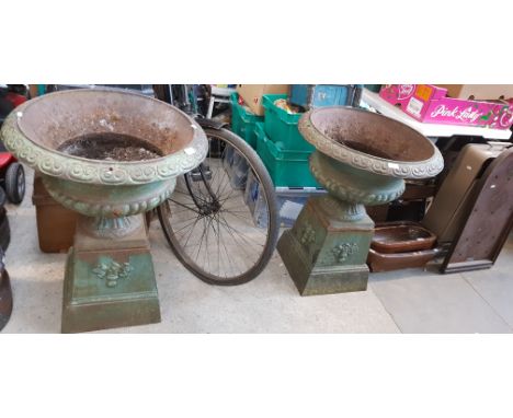 A pair of Victorian cast iron garden urns, height 77cm and width 61cm.Condition:- General wear through age and use, no sign o