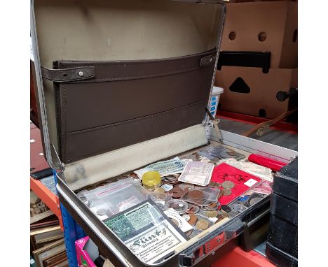 A briefcase of assorted world coins and banknotes. 