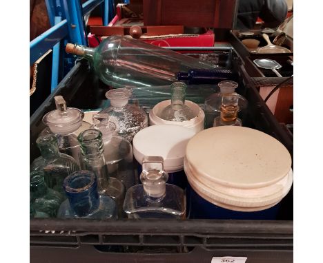 A box of assorted apothacary glass bottles and ceramic jars. 