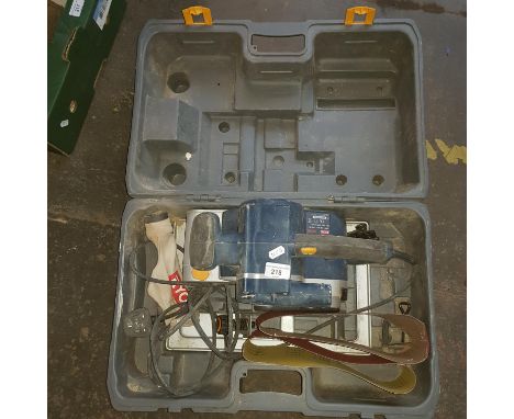 A Ryobi belt sander in box 