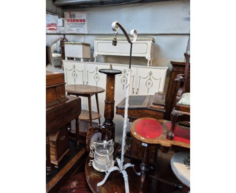 A wrought metal standard lamp and a wrought metal and glass light shade. 