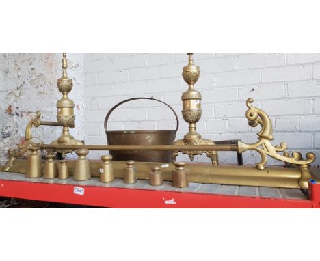 A brass fender, fire dogs, jam pan and weights
