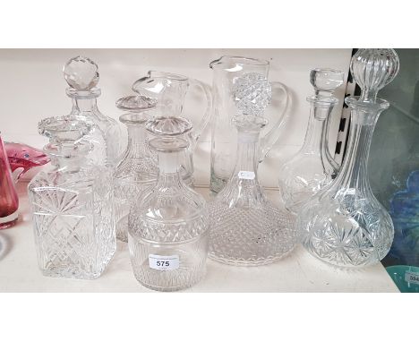 7 glass decanters including a ships decanter together with 2 tall jugs