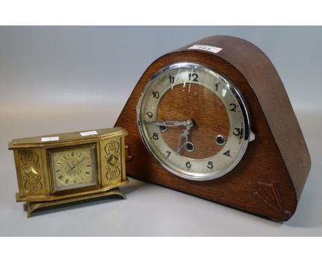 Mid century three train oak art mantel clock, together with a brass alarm clock with Roman face and back winding movement. (2