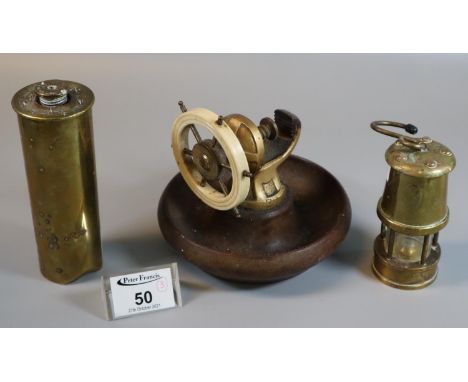 Ship's wheel type nutcracker with wooden dish base, together with miniature brass miner's safety lamp and a Second World War 
