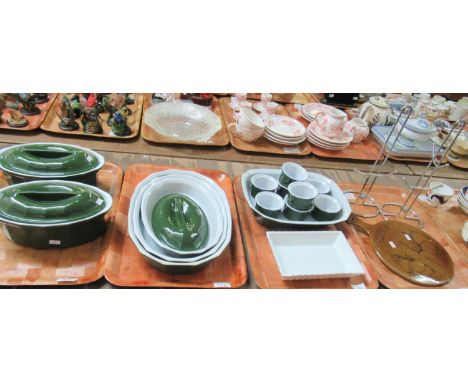 Four trays of French pottery by Emile Henry in dark green and white to include: two lidded casserole dishes, three graduated 