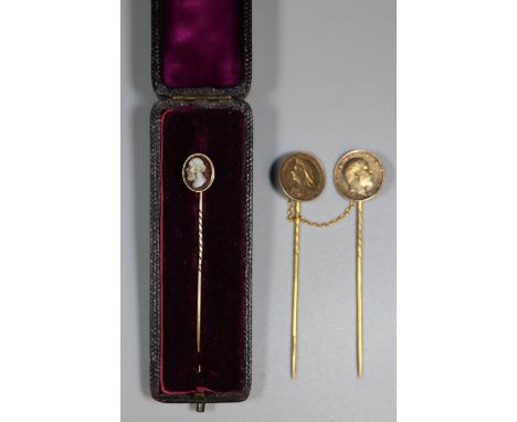 A cloak clasp made with an 1899 and a 1902 coin and a cased stick pin set with a hardstone cameo.(B.P. 21% + VAT) 