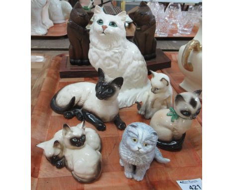 Collection of china cats, together with a pair of carved wooden cat bookends. China cats include: two Beswick china Siamese c