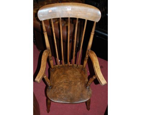 An early 20th century elm and beech stick back farmhouse open armchair