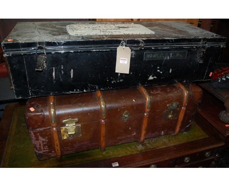 An early 20th century canvas, leather and wooden bound travelling trunk; together with a black painted metal munitions trunk 